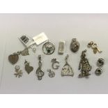 A collection of silver charms and pendants includi