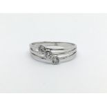 A 14ct white gold three stone diamond ring, approx .15ct, approx 2.3g and approx size O-P.