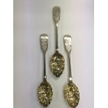 A pair of silver berry spoons plus one other match