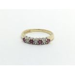 An 18carat gold ring set with alternating ruby and diamonds ring size I-J