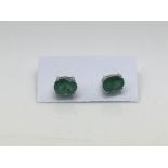 A pair of emerald ear studs set in silver.