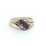 A 9ct gold ring set with two small diamonds and three faux rubies, approx 3g and approx size L.