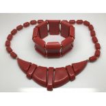 A circa 1950s early red plastic necklace and match