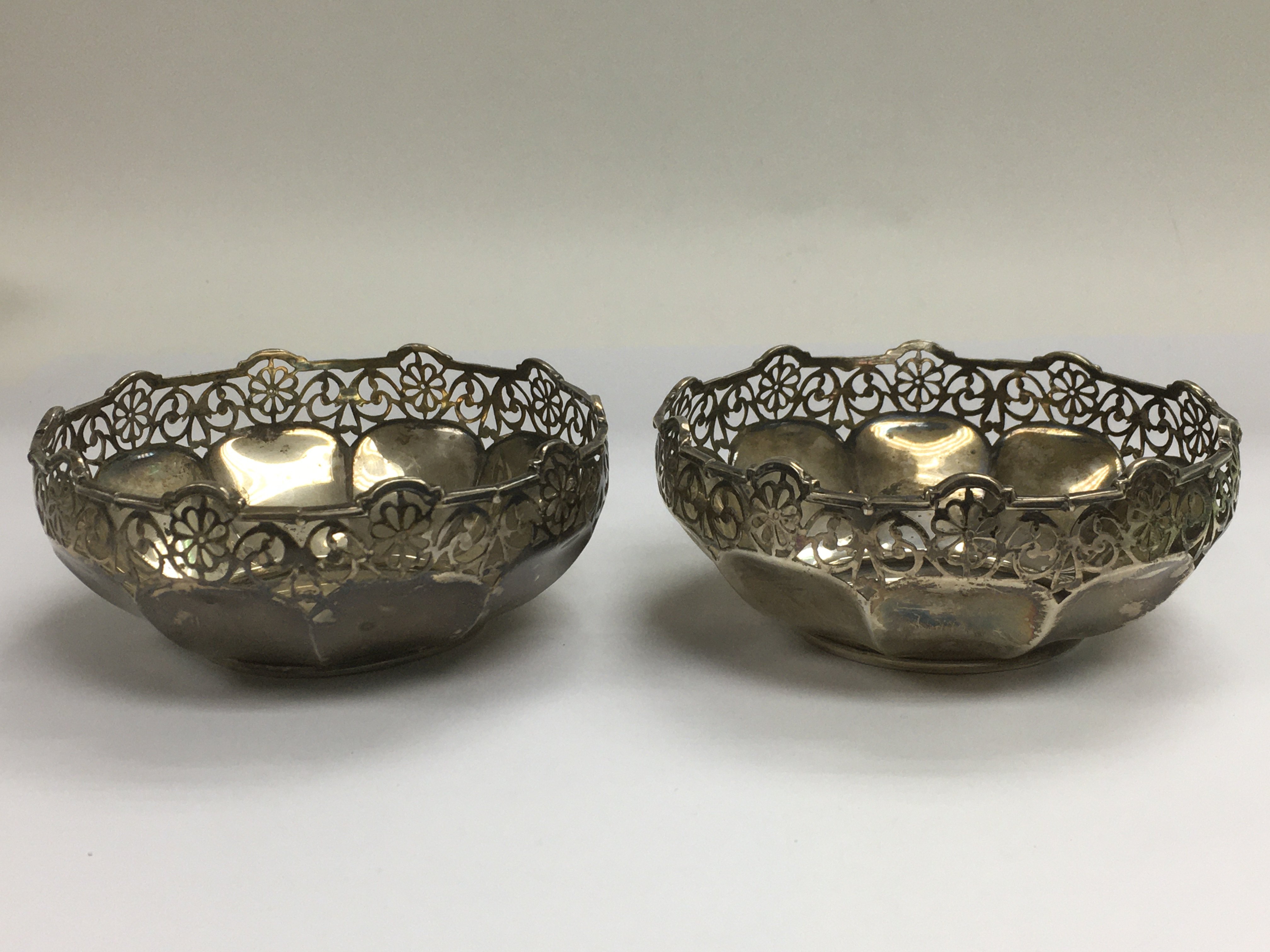 A pair of silver dishes with piercework decoration