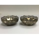 A pair of silver dishes with piercework decoration