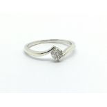 A 9ct white gold ring set with seven small diamonds in the form of a flowerhead, approx 1.8g and