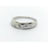 A 9ct white gold three stone diamond ring, approx .10ct, approx 1.4g and approx size P.