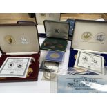 A collection of cased British commemorative coin s