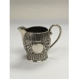 A small Victorian silver jug with floral and reede