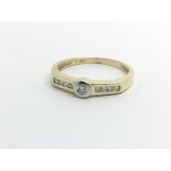 A 9ct gold solitaire diamond ring with further diamonds to the shoulders, approx.10ct, approx 1.9g