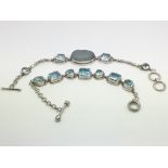 Two silver bracelets, one set with blue topaz and