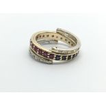 A 9ct gold flip flap ring set with diamonds, rubies and sapphires, approx 4.4g and approx size K.