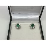 A boxed pair of 18ct white gold ear studs set with