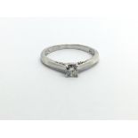 A 9ct white gold solitaire diamond ring with furth