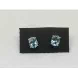 A pair of blue topaz ear studs set in silver.