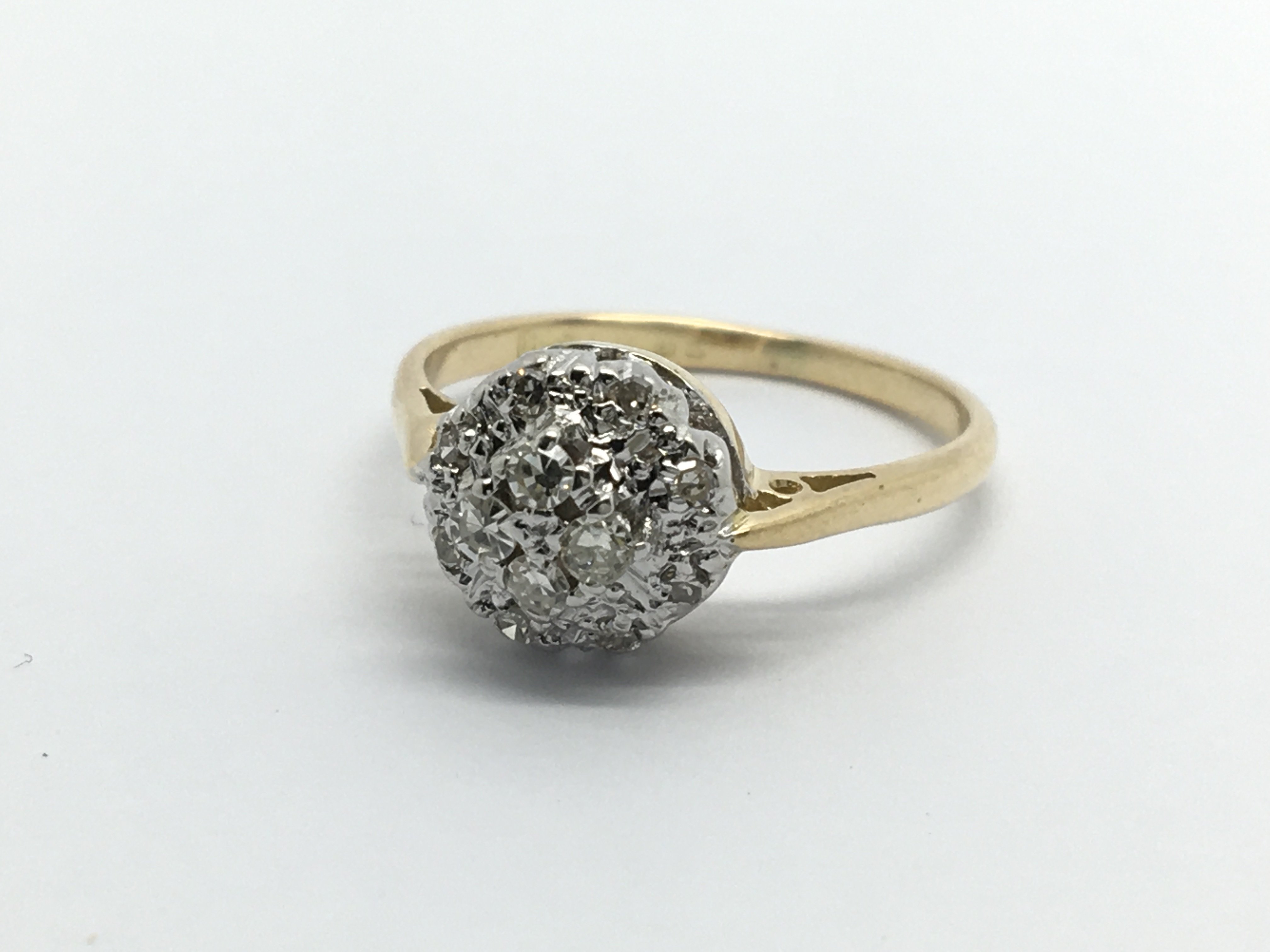An 18ct white gold diamond cluster ring, approx .1