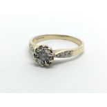 An 18ct gold solitaire diamond ring with further d