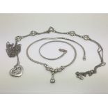 Three silver necklaces set with clear stones.