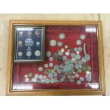 A display case of coins plus a framed British Ster