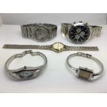 A collection of five watches including Gucci, DKNY