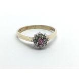 A 9ct gold ring set with a central ruby surrounded by diamonds, approx 1.8g and approx size N.