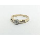 A 9carat gold ring set with a solitaire diamond 0.15 the shank with further diamonds ring size P.