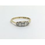 An 18ct gold and platinum three stone diamond ring, approx 1.7g and approx size J.