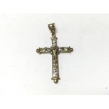 A 9ct gold crucifix pendant set with white stones.