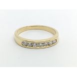 An 18ct gold ring set with seven diamonds, approx .33ct, approx 2.8g and approx size N-O.