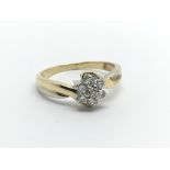 An unmarked gold ring set with seven small diamonds, approx 3.1g and approx size M.