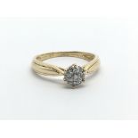 An 18ct gold diamond cluster ring in the form of a flowerhead, approx .15ct, approx 2.3g and