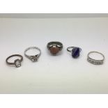 Five rings including silver and gem set examples.