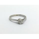 An unmarked white gold solitaire diamond ring, old