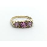 A 9ct gold ring set with three pink stones, approx