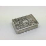 A small silver box with chased decoration to the l