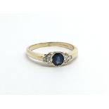 An 18ct gold ring set with a central sapphire and six small diamonds, approx 2.6g and approx size J-