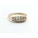 A vintage 18ct gold ring set with five diamonds, approx 2.7g and approx size P.