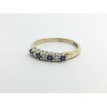 A 9ct gold ring set with four sapphires and three diamonds, approx 1.5g and approx size M-N.