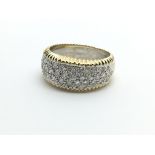 An 18ct white and yellow gold diamond cluster ring, approx 1ct, approx 7.9g and approx size M.