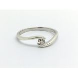 A 9ct white gold solitaire diamond ring, approx .10ct, approx 1.5g and approx size N.