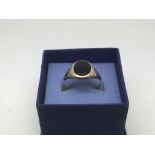 A 9ct gold signet ring set with black agate, appro