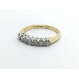 An 18ct gold seven stone diamond ring, approx 1/3c