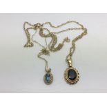 Two yellow metal pendants set with stones, approx