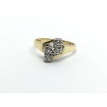 An 18ct gold ring set with four diamonds, approx 3