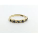 An 18carat gold ring set with alternating sapphire and diamonds ring size N.