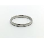 A platinum ring set with three small diamonds, approx 2.3g and approx size M.