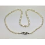 A graduated row of cultured pearls with a silver c