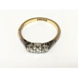 An 18carat gold and platinum ring set with three brilliant cut diamonds approximately 0.20 of a