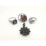 Three silver rings, one set with amethyst, one set