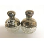 A matching pair of hallmarked silver and cut glass